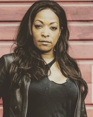 Kellita Smith looks beautiful in a black jacket with her long hair.